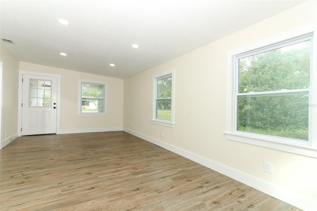 unfurnished room with light hardwood / wood-style floors