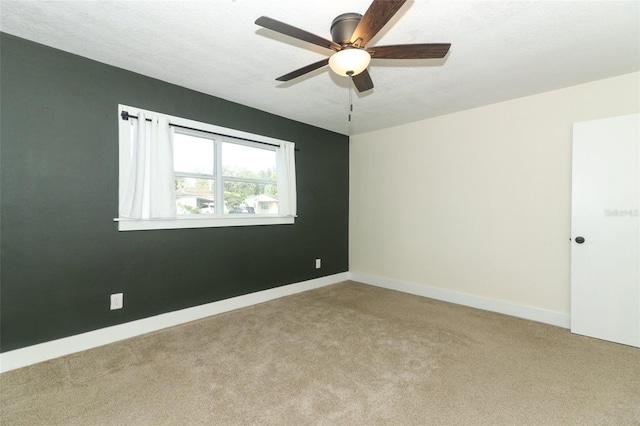 unfurnished room with a textured ceiling, light carpet, and ceiling fan