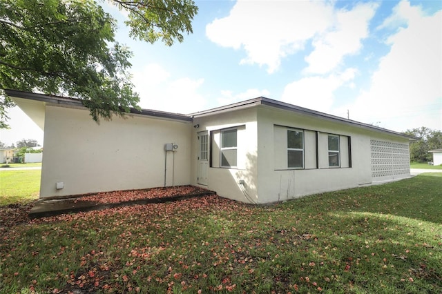 view of side of home with a lawn