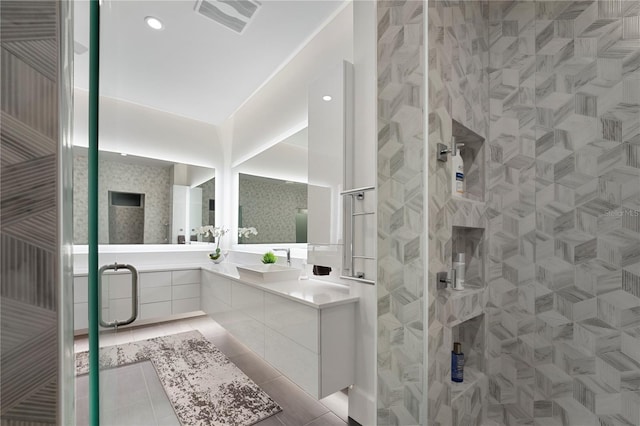 bathroom featuring vanity, tile patterned floors, and walk in shower