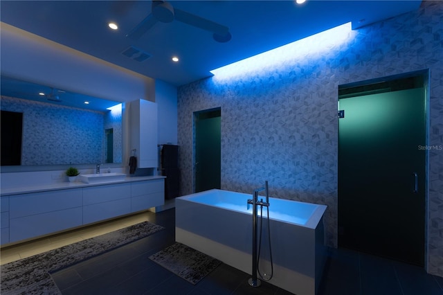 bathroom featuring a tub, tile patterned flooring, and vanity