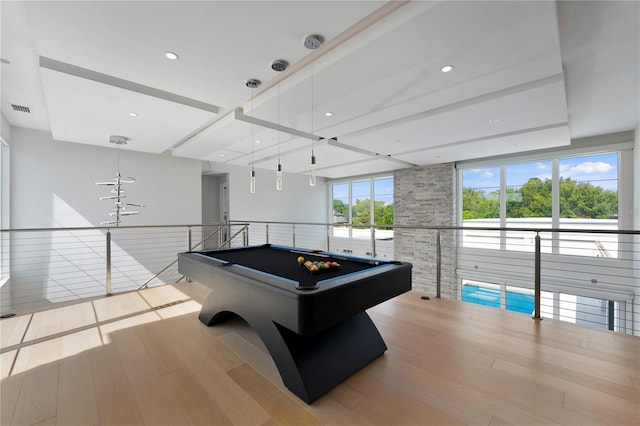 recreation room featuring beamed ceiling, light hardwood / wood-style floors, a wealth of natural light, and pool table