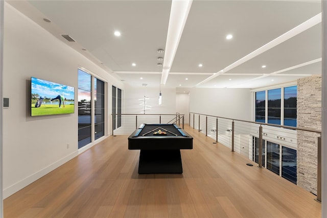 recreation room featuring pool table, beamed ceiling, and light wood-type flooring