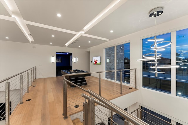 interior space featuring hardwood / wood-style floors and an inviting chandelier