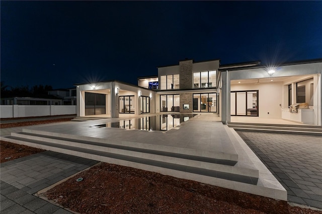 back house at night with a patio area