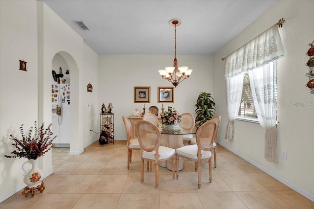 dining room featuring a chandelier and light tile floors