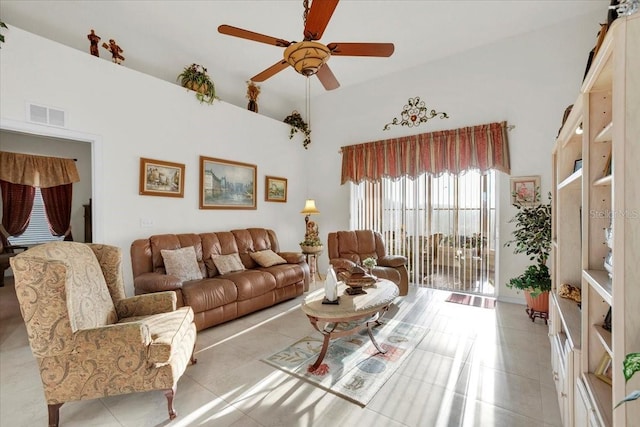 tiled living room featuring a high ceiling and ceiling fan