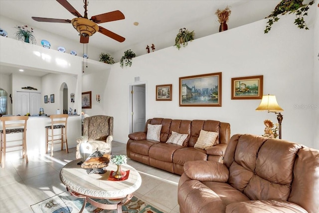 tiled living room with ceiling fan