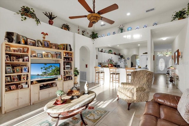 tiled living room with ceiling fan