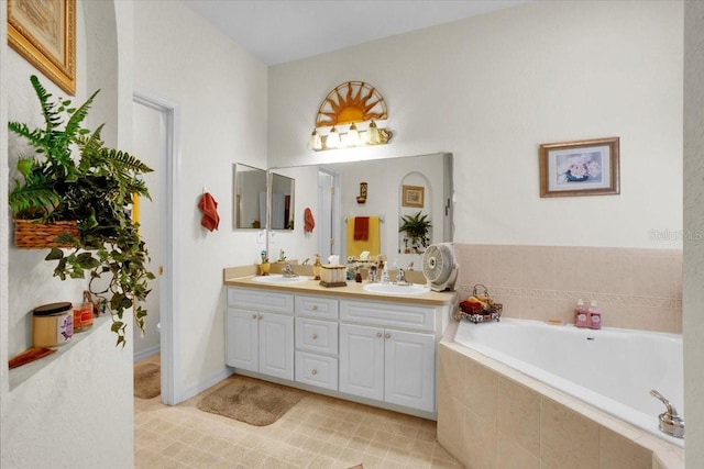 bathroom with a relaxing tiled bath, vanity with extensive cabinet space, double sink, and tile floors