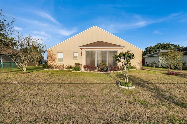 back of house featuring a lawn