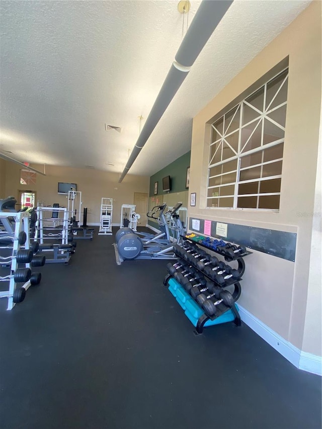 exercise room featuring a textured ceiling