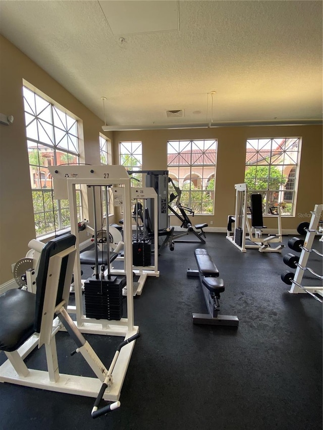 gym featuring a textured ceiling