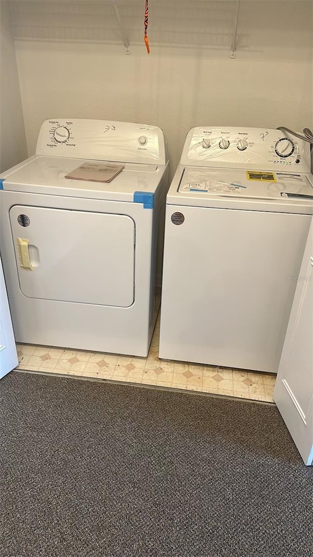 laundry room with washing machine and clothes dryer