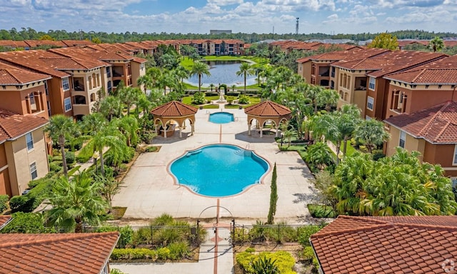 view of swimming pool with a gazebo, a patio area, and a water view