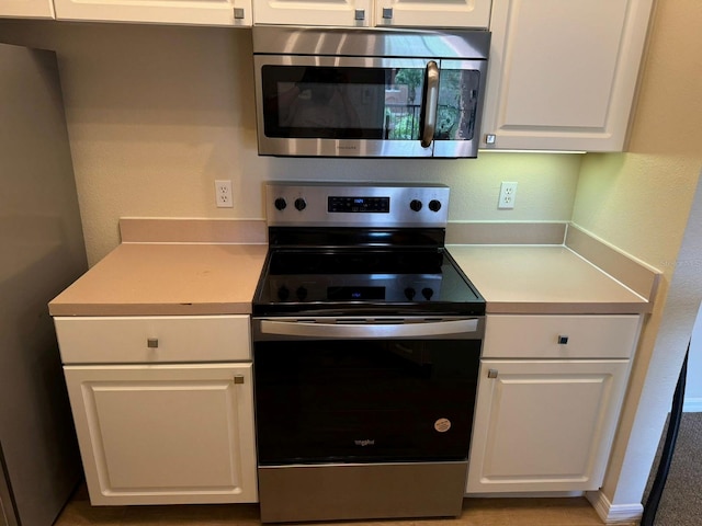 kitchen with white cabinetry and appliances with stainless steel finishes