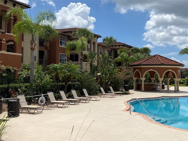 view of swimming pool featuring a gazebo and a patio