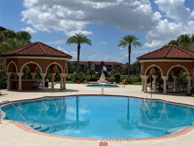 view of swimming pool featuring a gazebo and a patio area