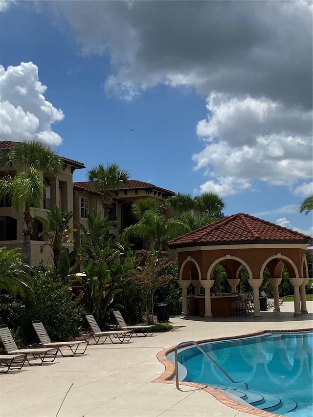 view of swimming pool with a gazebo and a patio area