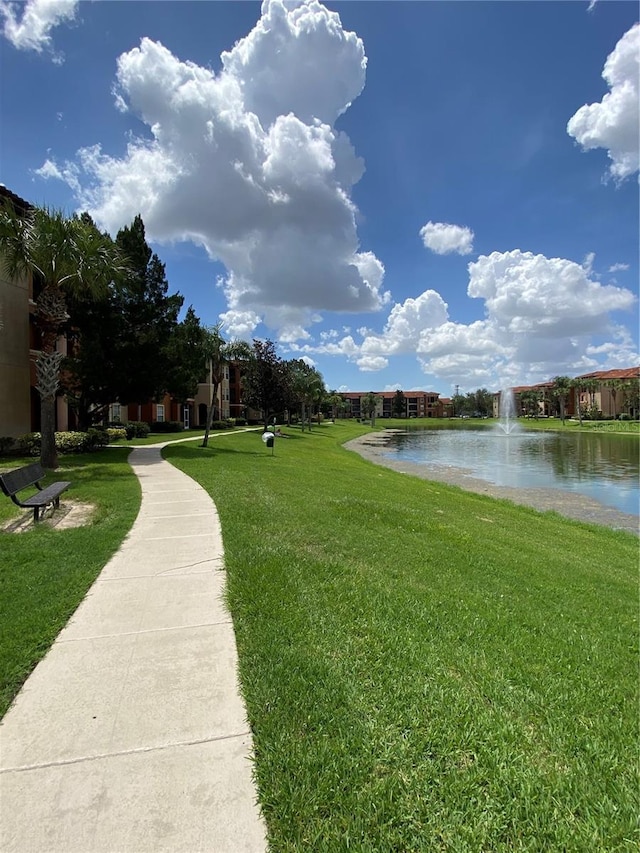 view of community featuring a water view and a yard