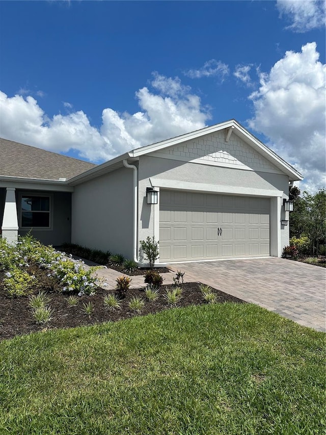 view of front of house featuring a garage and a front lawn