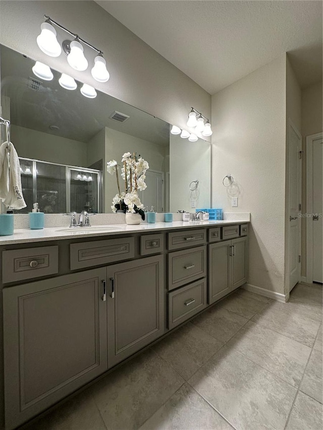 bathroom with tile floors, large vanity, and double sink