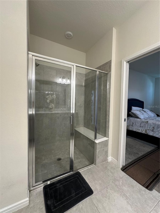 bathroom featuring an enclosed shower and tile floors