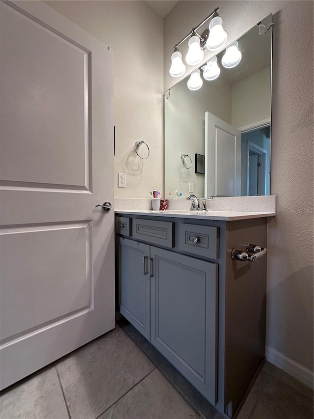 bathroom with tile floors and vanity