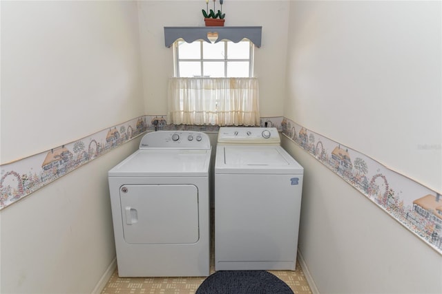 washroom with washing machine and clothes dryer and light tile floors