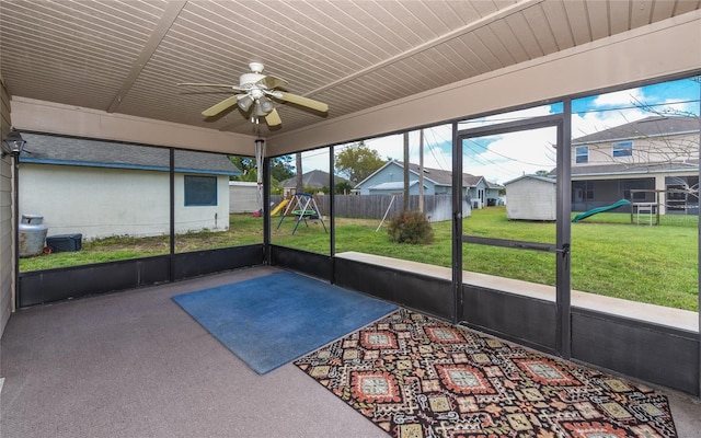 unfurnished sunroom featuring ceiling fan