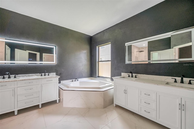 full bathroom with a walk in shower, marble finish floor, double vanity, and a sink