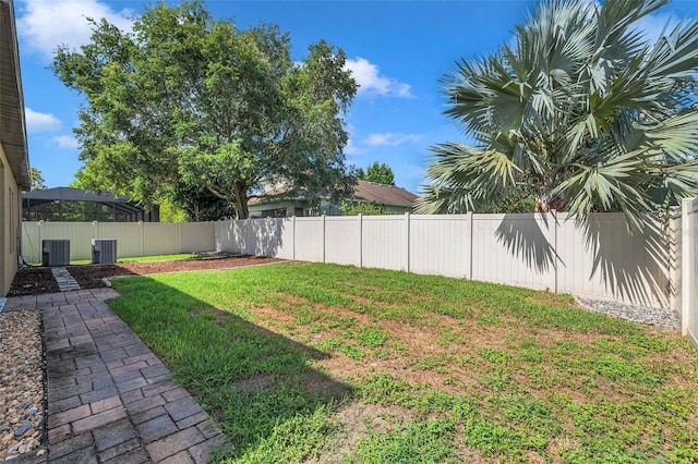 view of yard featuring a fenced backyard and central air condition unit