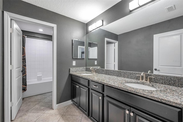 full bathroom featuring double vanity, tile patterned flooring, a sink, and visible vents