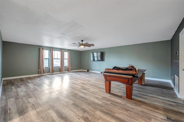 recreation room featuring ceiling fan, baseboards, and wood finished floors