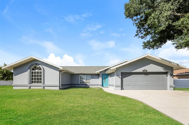 ranch-style home with a garage and a front lawn