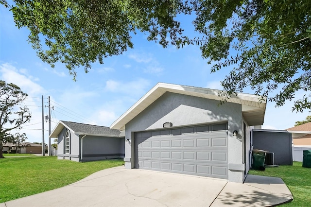 ranch-style home with a garage and a front lawn