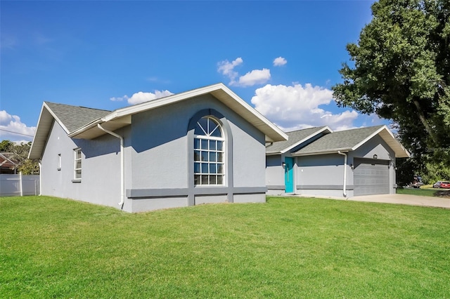 view of front facade with a garage and a front lawn