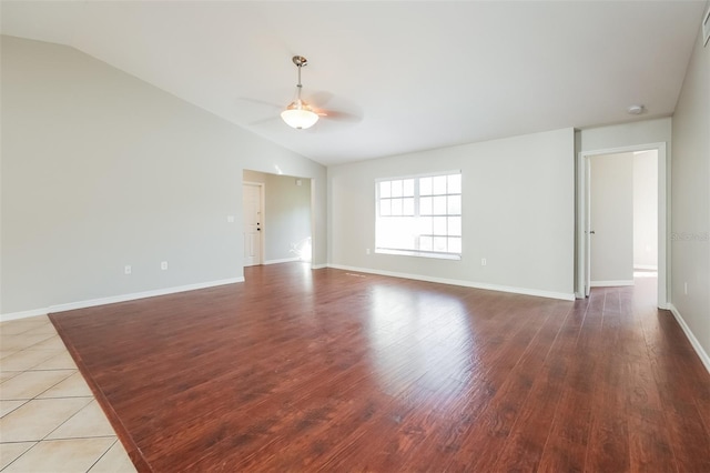 empty room with tile floors, lofted ceiling, and ceiling fan