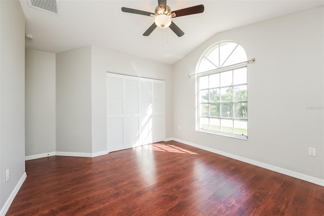 unfurnished bedroom with hardwood / wood-style flooring, a closet, ceiling fan, and vaulted ceiling