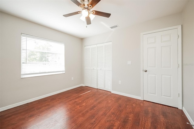 unfurnished bedroom featuring wood-type flooring, a closet, and ceiling fan