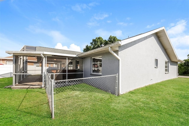 back of property featuring a lawn