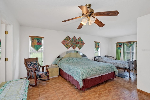 bedroom featuring multiple windows and ceiling fan