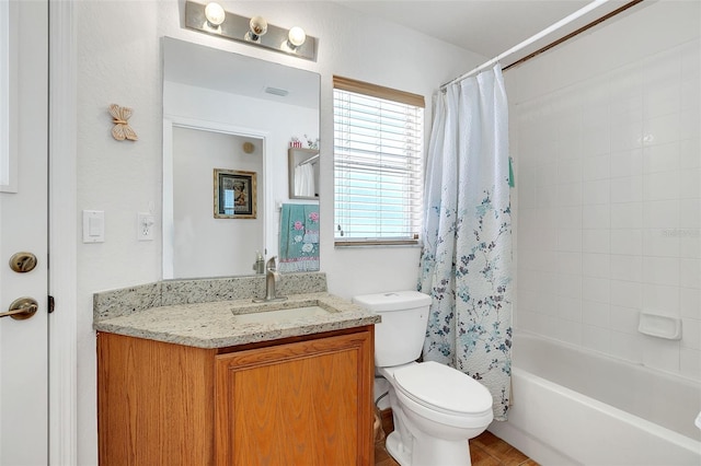 full bathroom with vanity, shower / tub combo, and toilet