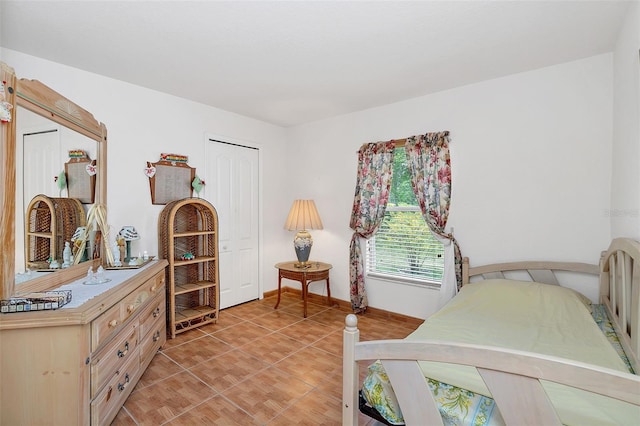 tiled bedroom with a closet