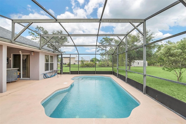 view of pool with a yard, a patio, and glass enclosure