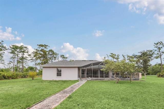 back of house with a yard and a lanai