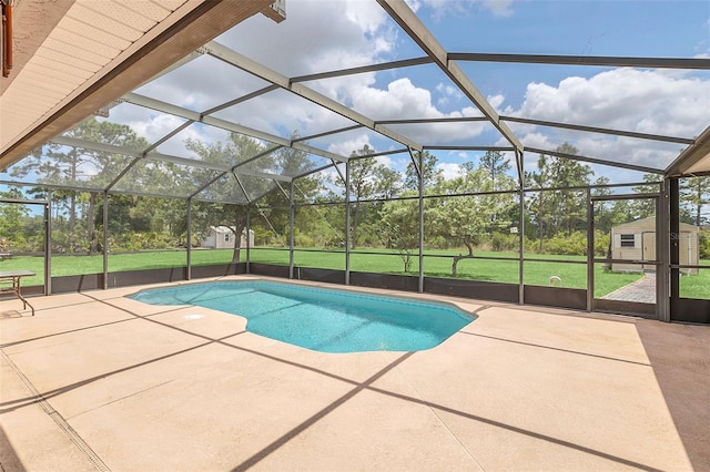 view of swimming pool with a storage shed, a lanai, a patio area, and a yard