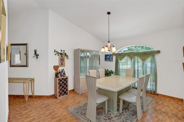 dining room with an inviting chandelier and vaulted ceiling