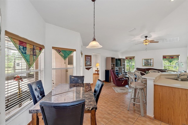 dining room with sink, light tile patterned floors, and ceiling fan