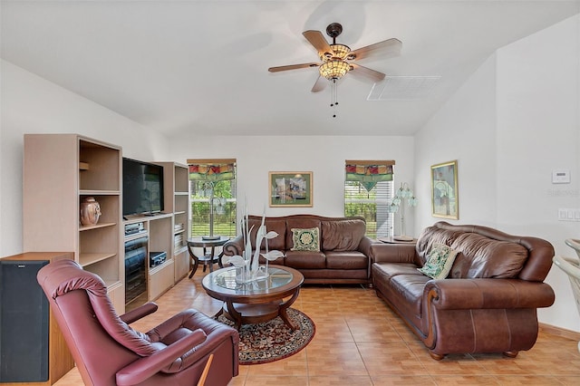 tiled living room with ceiling fan and a wealth of natural light